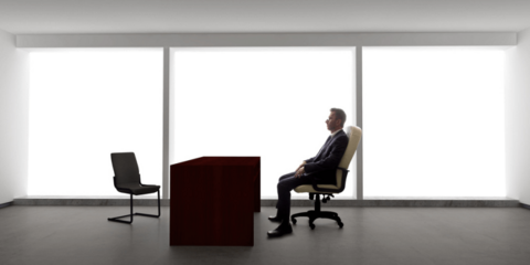 Mann sitzt in einem leeren Raum auf einen Bürostuhl